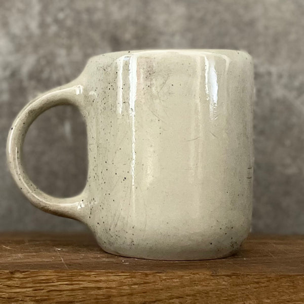 Speckled mug with words about work