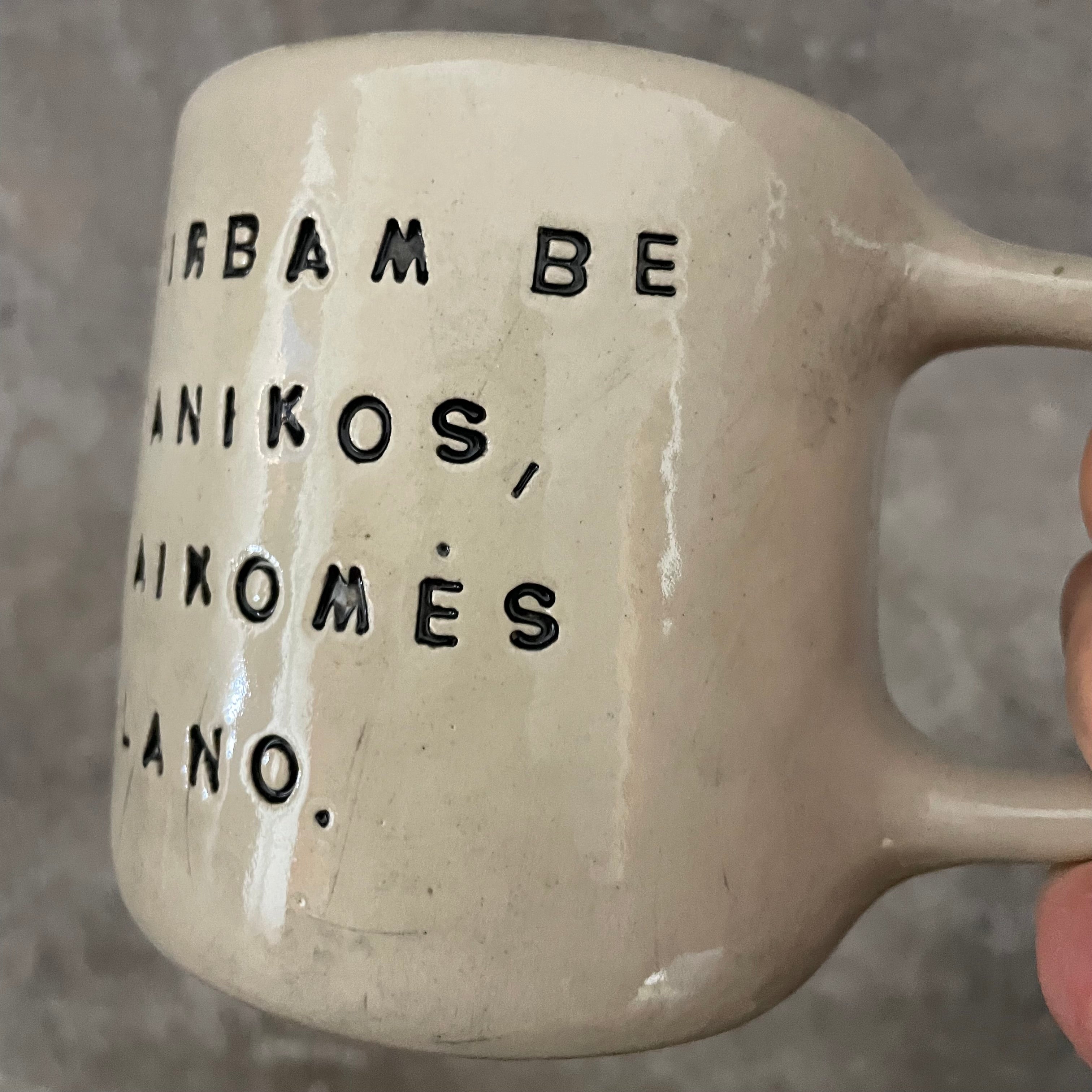 White medium ceramic mug with words about work