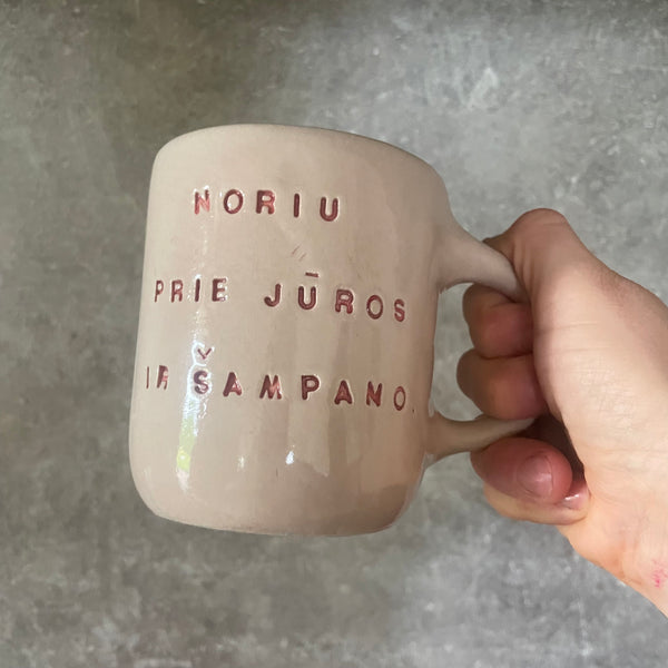 Pink mug with saying in Lithuanian