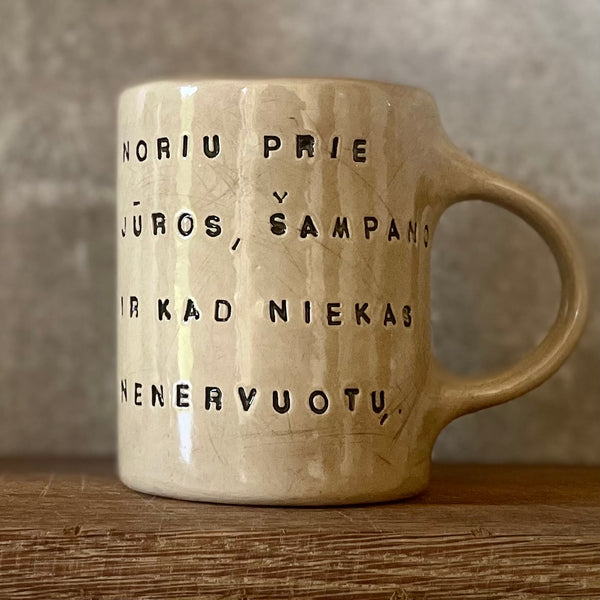 Cozy greenish mug with saying in Lithuanian