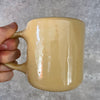 Yellow ceramic mug about luck