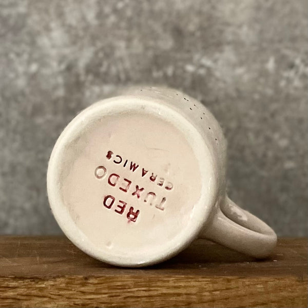 Pale pink mug with prosecco saying