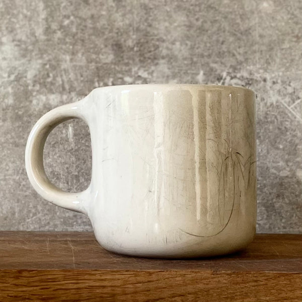 White medium ceramic mug with words about work