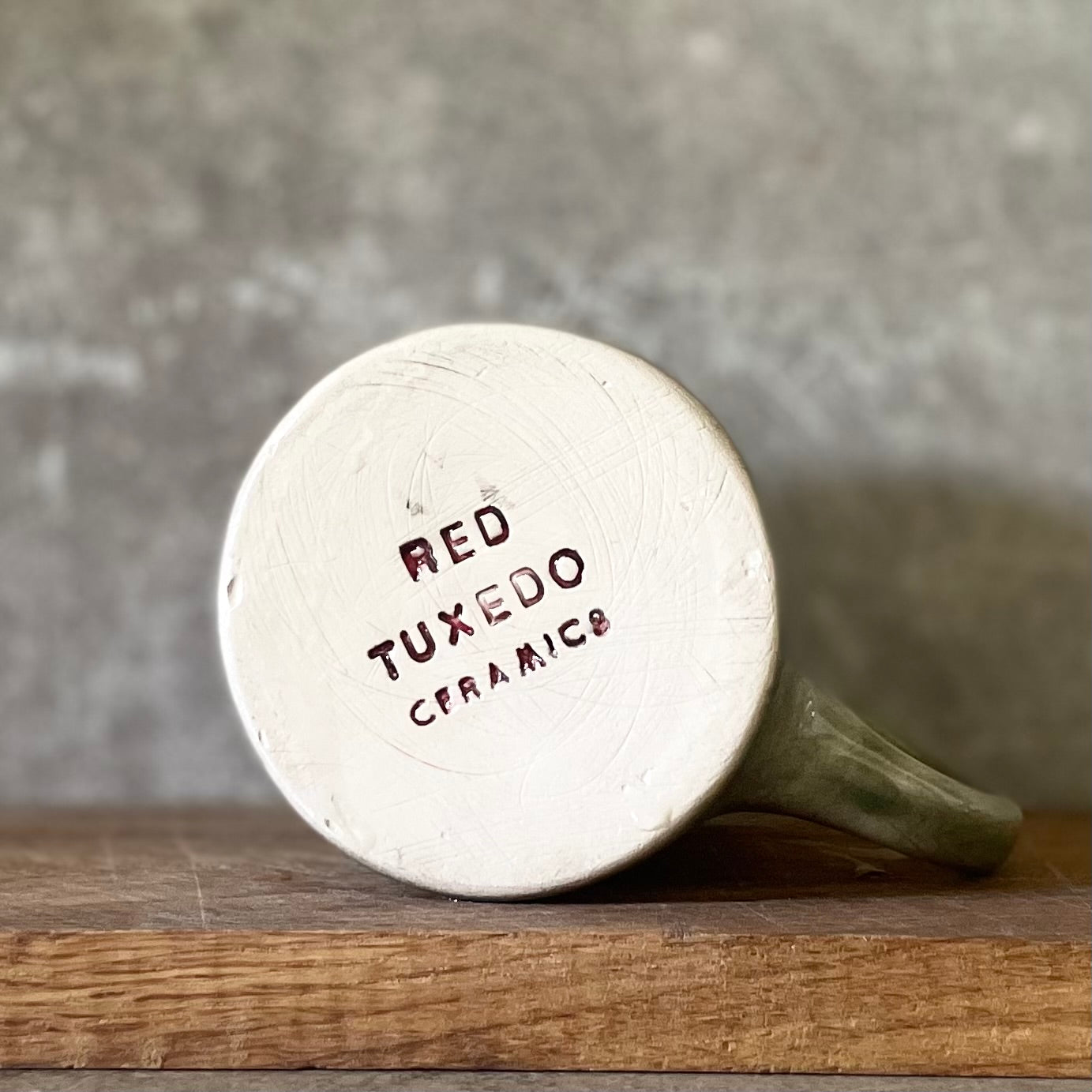 Green ceramic mug with words about work