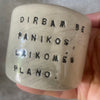 A set of small mugs with words in Lithuanian