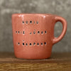 Small red mug with words in Lithuanian