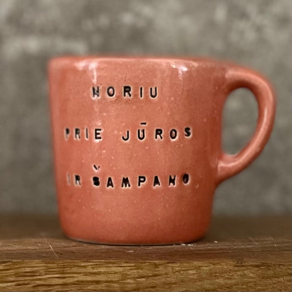 Small red mug with words in Lithuanian