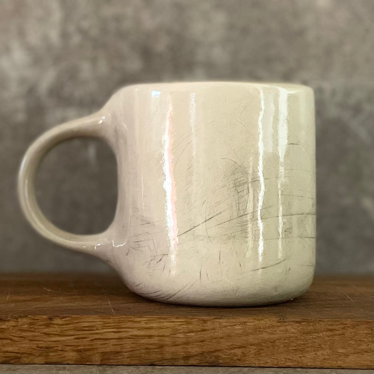White irregular mug with words about work