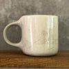 White irregular mug with words about work