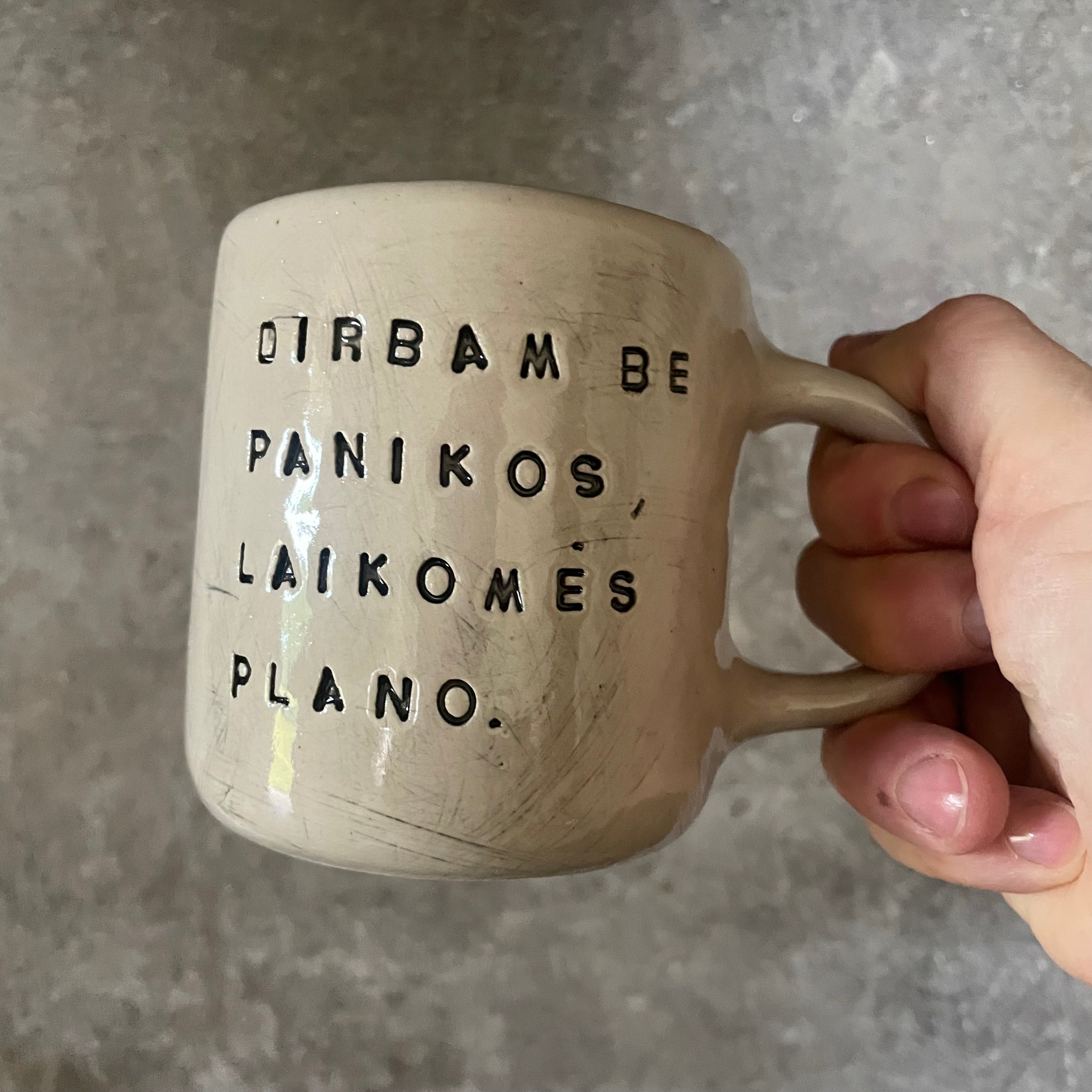 White medium ceramic mug with words about work