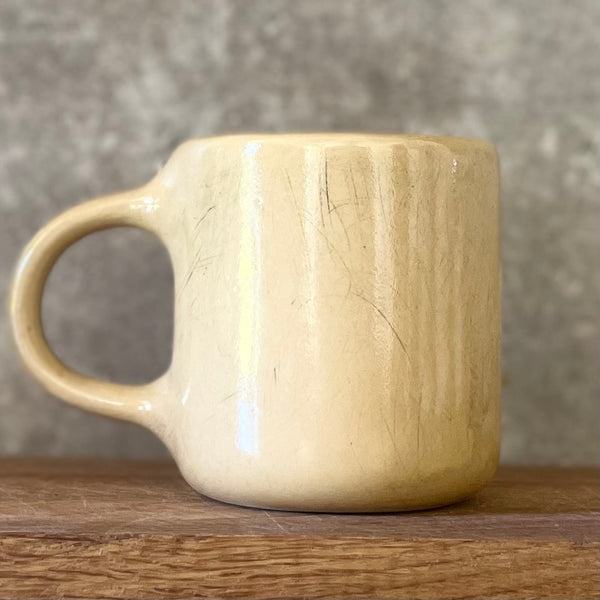 Yellow mug with words about work