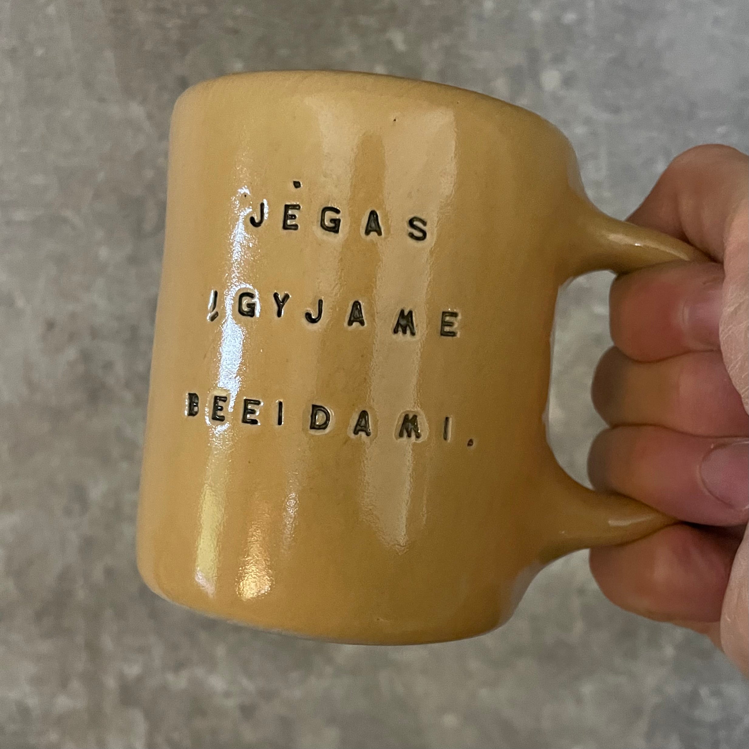 Yellow ceramic mug with quote by Vergil
