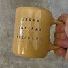 Yellow ceramic mug with quote by Vergil