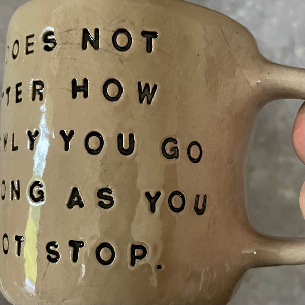 Beige mug with quote by Confucius