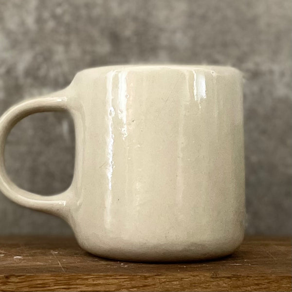 White medium ceramic mug with words about work