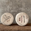 A set of small mugs with words in Lithuanian