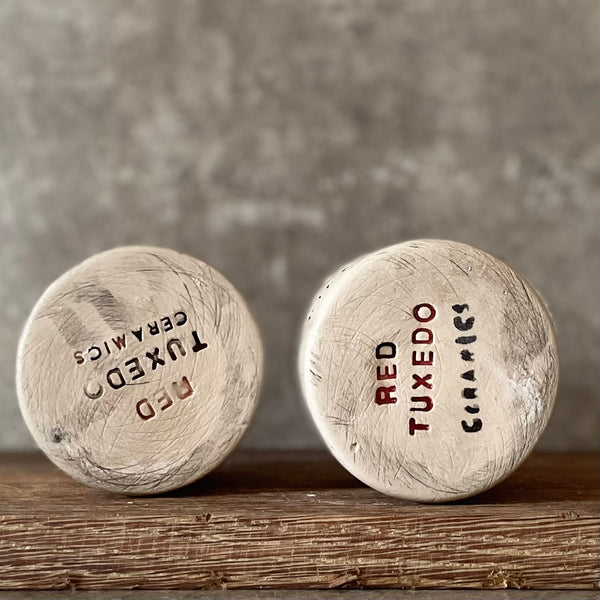 A set of small mugs with words in Lithuanian