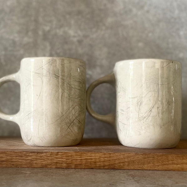 Two big ceramic mugs with words about work