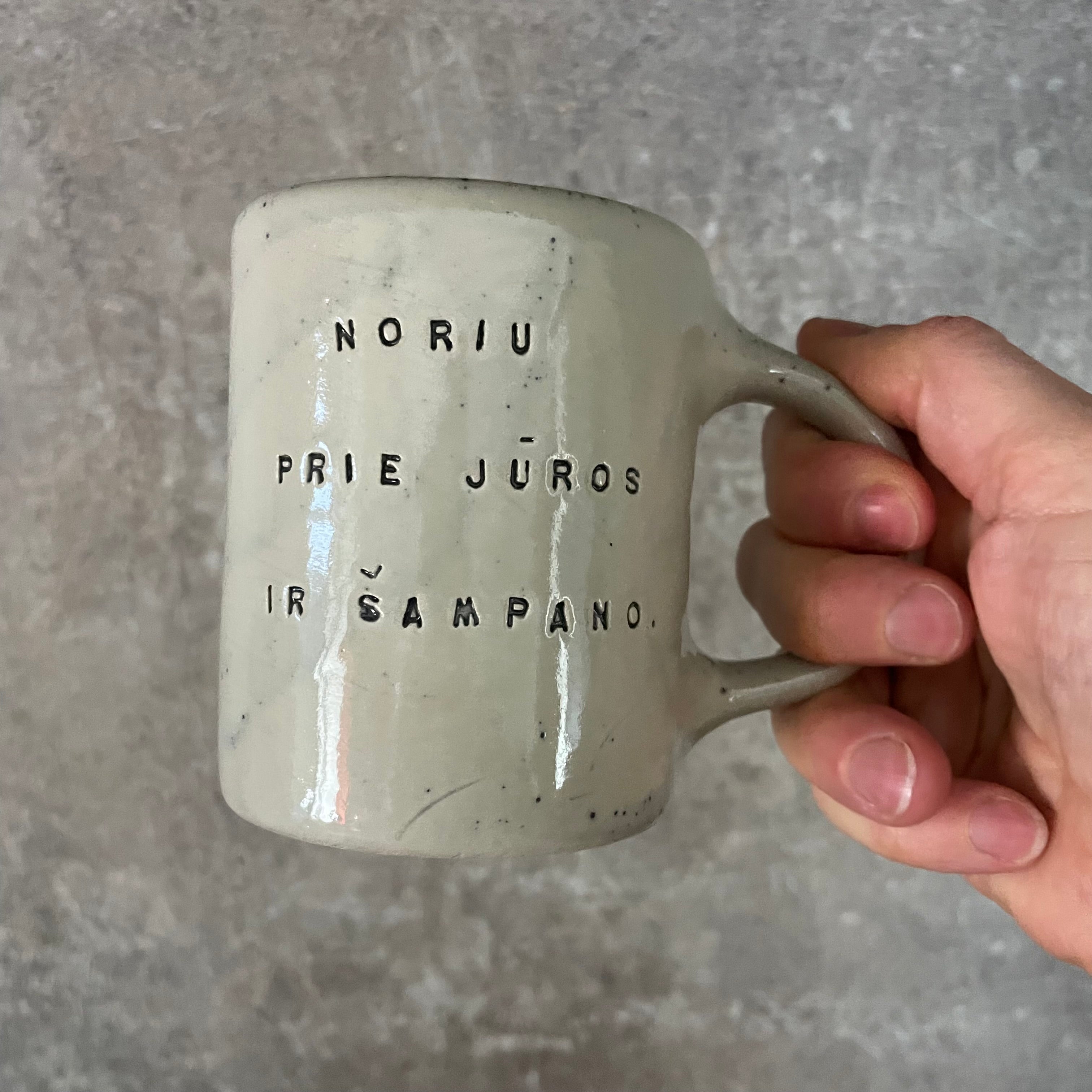 Speckled mug about champagne and the sea