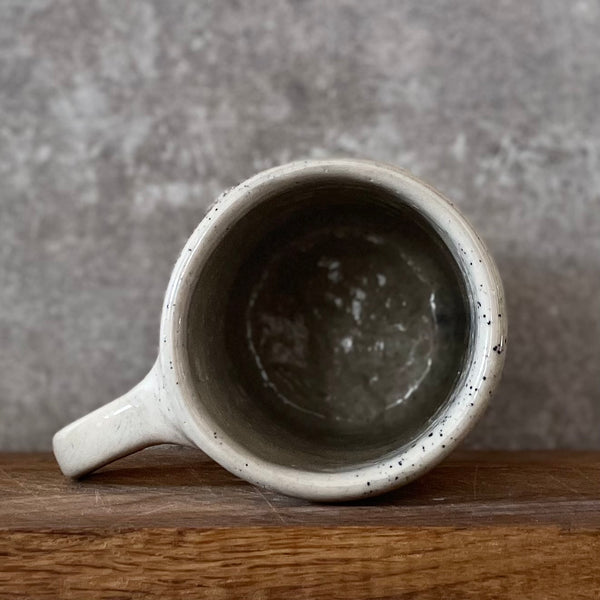 Speckled mug with words about work - another