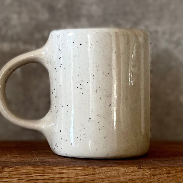 Speckled mug about champagne and the sea