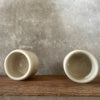 A set of small mugs with words in Lithuanian