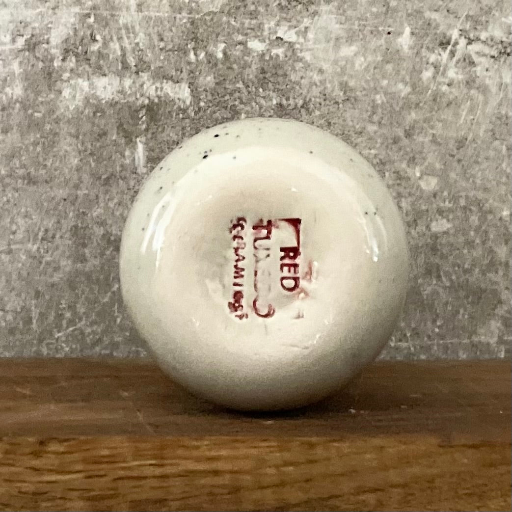 Small speckled mug without handle with text in Lithuanian