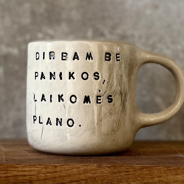 White medium ceramic mug with words about work