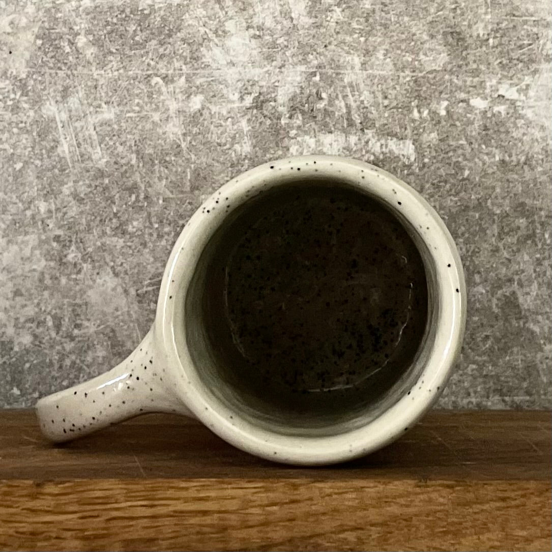 Speckled mug about champagne and the sea