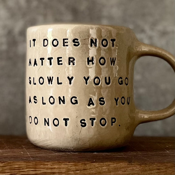 Beige mug with quote by Confucius