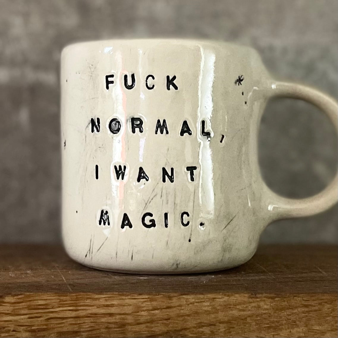 Ceramic mug with saying about magic