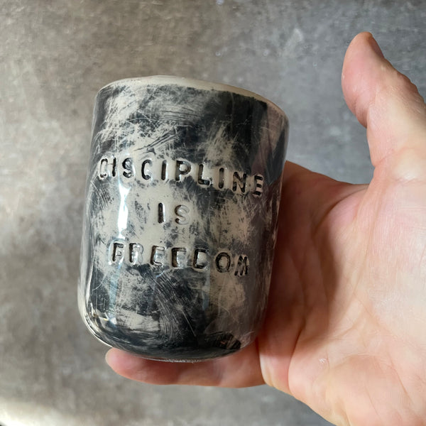 Small dark mug about discipline