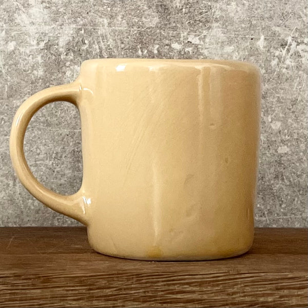 Yellow cup with saying "LABAS RYTAS"